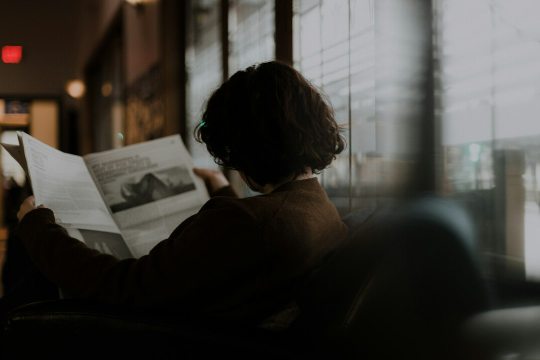 person reading newspaper