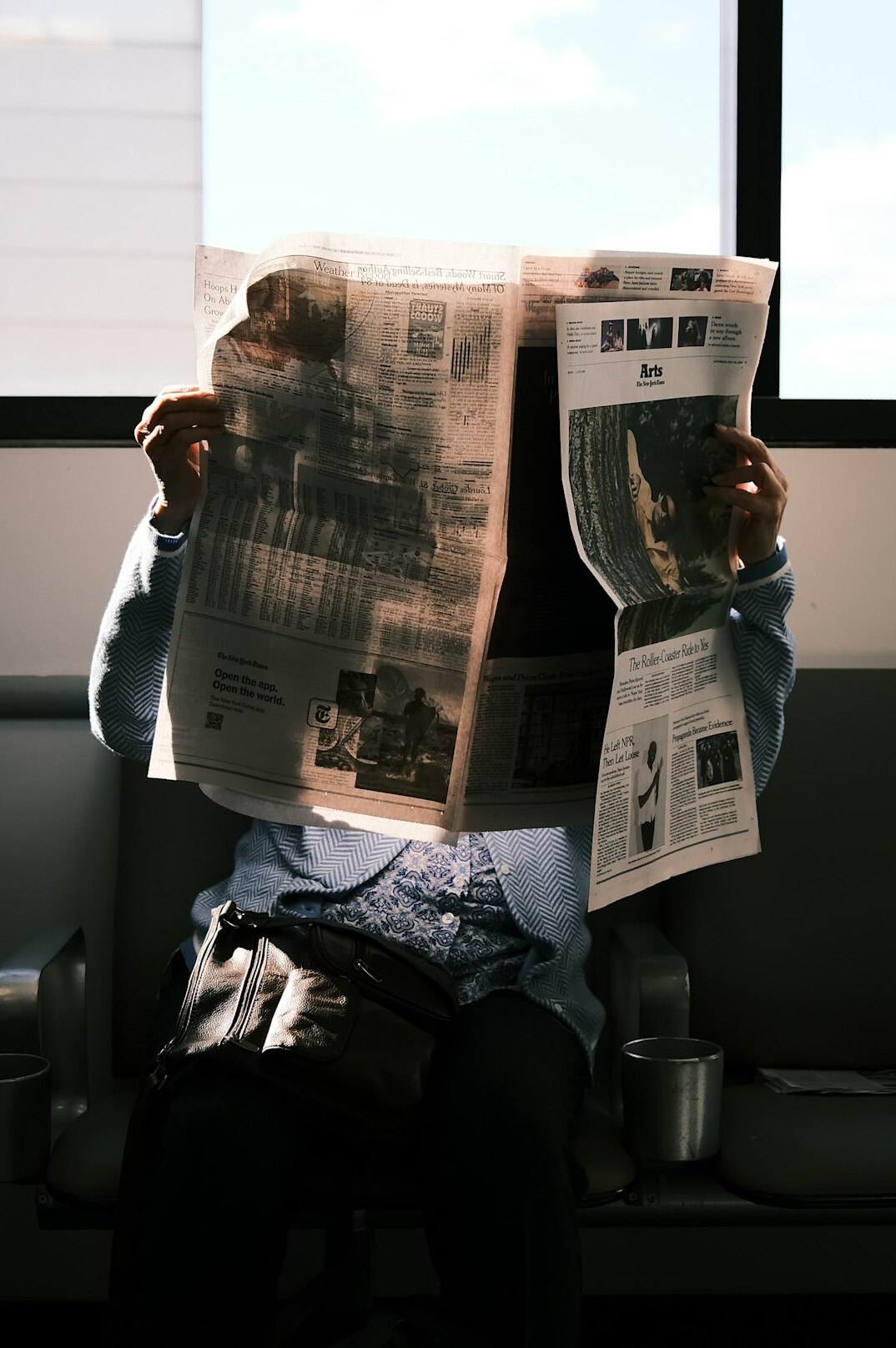 person reading newspaper